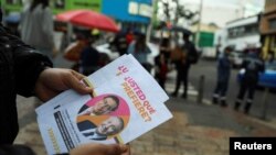 Un votante sostiene un volante con la imagen de los candidatos presidenciales Gustavo Petro y Rodolfo Hernández, en Bogotá, Colombia. (REUTERS/Luisa Gonzalez)
