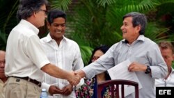 El jefe negociador del gobierno colombiano, Gustavo Bell (i), estrecha la mano del comandante del ELN Israel Ramírez Pineda (d), alias Pablo Beltrán, en La Habana.