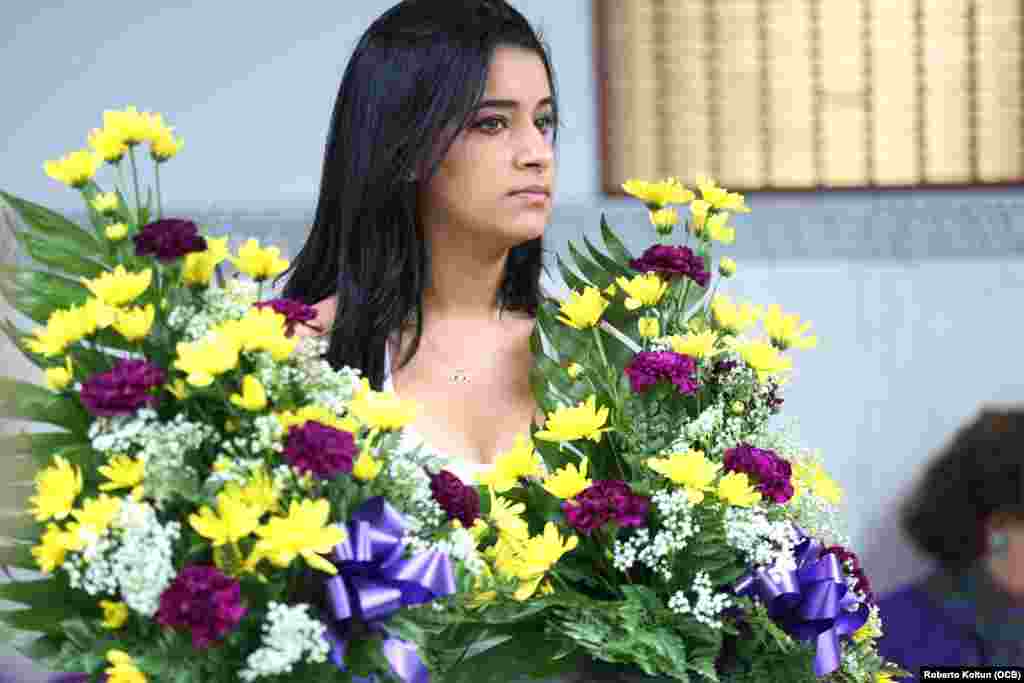 Una devota de San Lázaro acudió con ramos de flores a El Rincón, de Hialeah.
