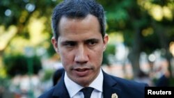 Venezuelan opposition leader Juan Guaido attends an interview with local media after the funeral of Father Francisco Jose Virtuoso