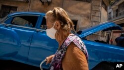 Una mujer, con mascarilla para protegerse del coronavirus, camina por La Habana. (AP/Ramón Espinosa)