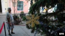 Una anciana observa un árbol de navidad en La Habana Vieja.