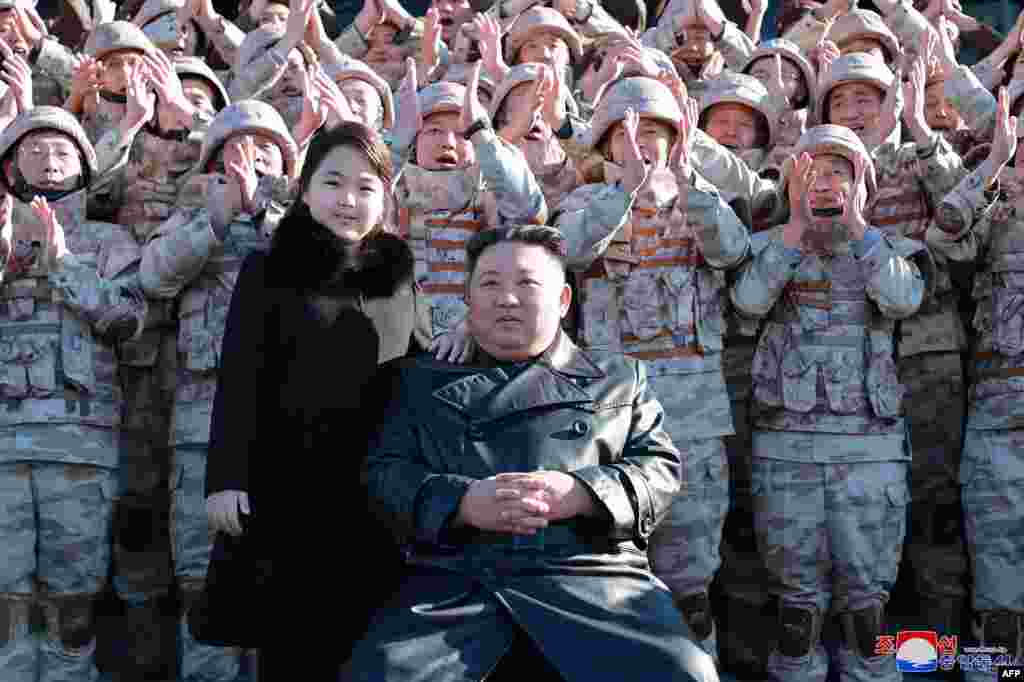 Kim Jong Un y su hija posan junto a soldados que contribuyeron a la prueba de fuego del nuevo misil balístico intercontinental. (Foto: KCNA VIA KNS / AFP)