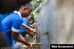 Alumnos de una escuela de Blantyre (Malaui) se lavan las manos en una instalación proporcionada por “Water for People”. (© Water for People)