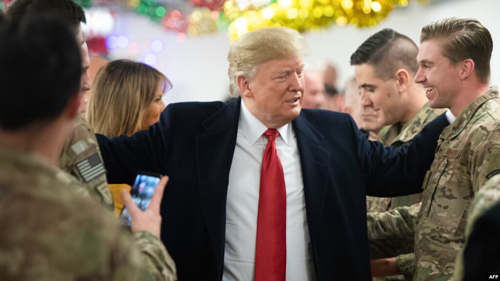 El presidente Donald Trump saluda a los soldados en la base aérea de Al Asad en Irak.