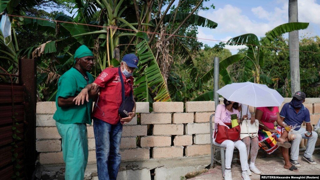 El curandero Jorge Goliat ayuda a un paciente en La Habana. (Alexandre Meneghini / Reuters).