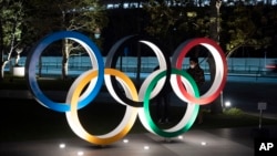 Los anillos olímpicos frente al nuevo Estadio Nacional de Tokio.
