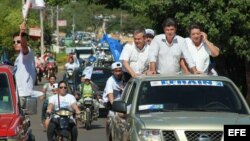 El candidato del Partido Liberal Radical Auténtico (PLRA), Efraín Alegre (2-d), junto al candidato del derechista Unace, Lino Oviedo Sánchez (3-d), durante un mitin conjunto, abril 2013
